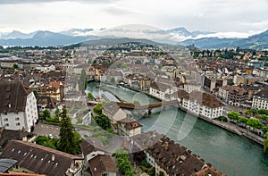 Tranquil river meandering through an idyllic townscape on a cloudy day in Lucern, Switzerland