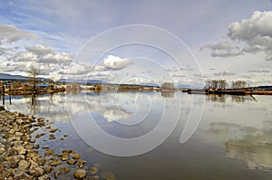 Tranquil river water reflecting sky and clouds