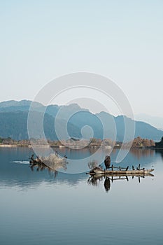 Tranquil scene featuring a small boat resting atop a lake in Shunhe Town in Tengchong City, China