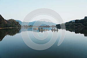 Tranquil scene featuring a small boat resting atop a lake in Shunhe Town in Tengchong City, China