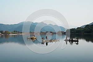 Tranquil scene featuring a small boat resting atop a lake in Shunhe Town in Tengchong City, China