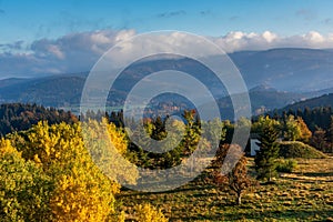 Tranquil scene of a grassy meadow with colorful trees. Kremnica Mountains, Slovakia.