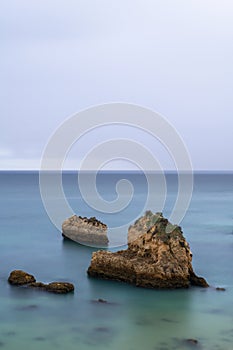 Tranquil scene of the rocks in the acean at the beautiful Ponta Joao de Arens in Portimao, Algarve photo