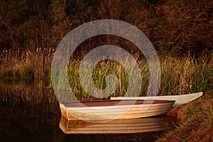 Tranquil scene of a small red and white fishing bo