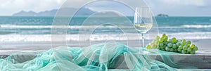 Tranquil scene white wine, grapes on wooden table, beach backdrop with yarn accents