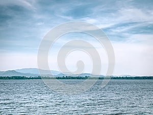 Tranquil Scenery of Lake and Mountain Against Moody Sky