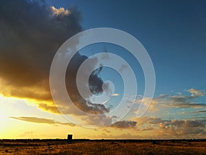 Tranquil scenery of a magical sunset over the meadows