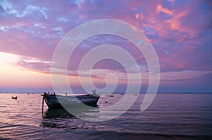 Tranquil sea with old fisherman boats at twilight