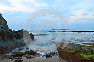 Tranquil Sea Water between Cliffs at Beach with Blue Sky and Island at Distance - Sitapur, Neil Island, Andaman, India