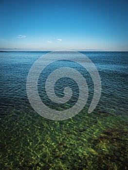 Tranquil seascape with green sky and sea water