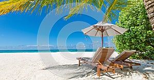 Tranquil summer vacation destination. Romantic getaway beach, chairs beds white sand with blue sky. Tropical landscape background