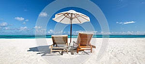 Tranquil summer vacation destination. Romantic getaway beach, chairs beds white sand with blue sky. Tropical landscape background