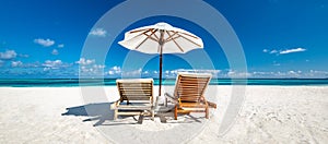 Tranquil summer vacation destination. Romantic getaway beach, chairs beds white sand with blue sky. Tropical landscape background