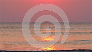 Tranquil sunrise over calm sea with