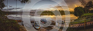 Tranquil sunrise over a lake and moored boats