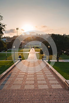 Tranquil Sunrise Scene with Stairs and Lamp Posts, Peaceful Atmosphere at Dawn or Dusk