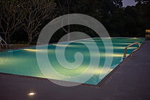 a tranquil swimming pool in the evening