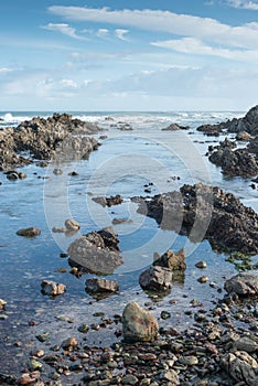 Tranquil tidal pool on a rocky beach in south Africa