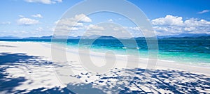 A tranquil tropical seascape on summer sunny, fantastic shadow of trees on pure sand beach