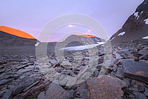 Tranquil vibrant sunset with insane red coloration of the glacier valley mountains photo