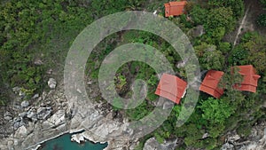Tranquil village on exotic asian island close to sea. Scenery aerial view on paradise island with local houses. Idyllic