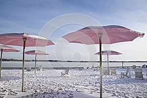 Tranquillity scene of beach chairs with umbrellas in winter photo