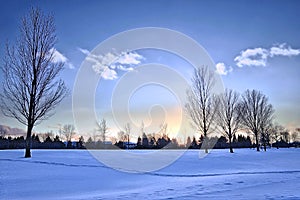 Tranquillity scene of sunset in the park after heavy snowfall photo