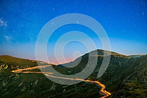 Transalpina road under a starry night, in Romania