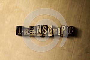 TRANSCRIPT - close-up of grungy vintage typeset word on metal backdrop