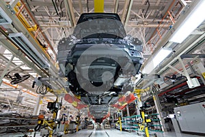 Transfer of car body bottom view. Robotic equipment makes the Assembly of car. Modern car Assembly at factory