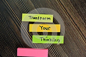 Transform Your Thinking write on sticky notes isolated on Wooden Table