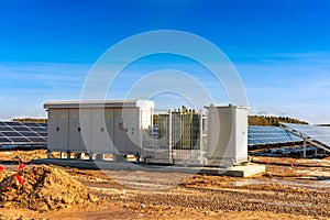 Transformer and inverters on the background of solar panels