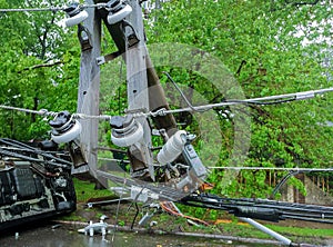 transformer on a pole and a tree laying across power lines over a road after Hurricane moved across