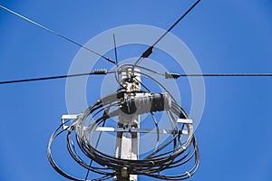 Transformer and power lines on electric pole. fiber optic tv and internet cable.