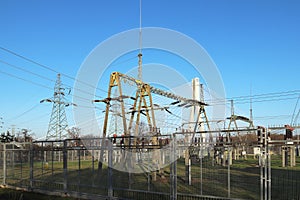 Transformer substation high voltage electrical network. Industrial energy. Metal structures in the open. Insulators and cable.