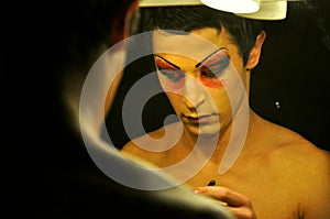 Transgender man, tabu concept image with man dressing up and putting make up