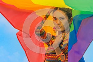 Transgender person posing with pride flag to celebrate of LGBTQIA right in pride month