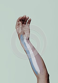 Transgender pride flag in a persons arm
