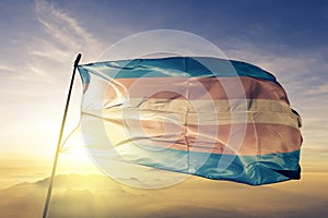 Transgender Pride flag textile cloth fabric waving on the top sunrise mist fog