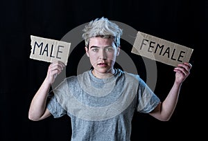 Transgender teenager breaking the word FEMALE into MALE. Gender identity and human rights concept