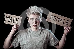 Transgender teenager breaking the word FEMALE into MALE. Gender identity and human rights concept