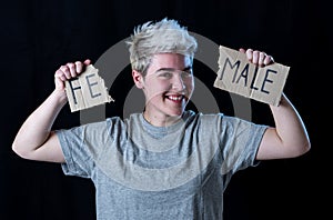 Transgender teenager breaking the word FEMALE into MALE. Gender identity and human rights concept