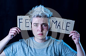 Transgender teenager breaking the word FEMALE into MALE. Gender identity and human rights concept