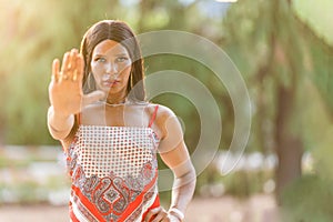 Transgender woman gesturing stop with the hand outdoors