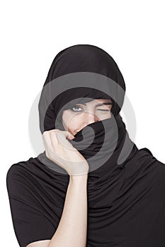 Transgressive girl wearing a burqa and uncovering