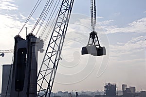 Transhipment terminal for discharging cement cargo by shore cranes. A view of berths with cargo ships and the water area of the po photo