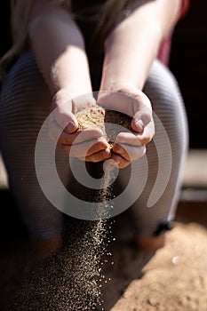 Transience of time - sand in children`s hands as a symbol of inevitable maturation