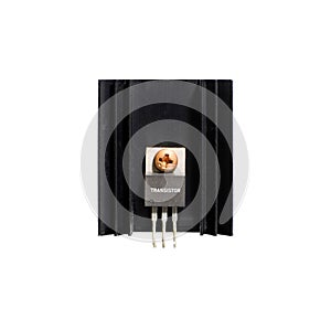 Transistor on heatsink of electronic amplifier on white background