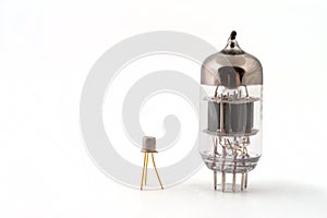 Transistor next to a vacuum tube photo