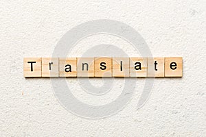 Translate word written on wood block. Translate text on cement table for your desing, concept